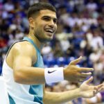 Carlos Alcaraz sorridente durante un match di esibizione