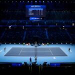 Campo da tennis con spalti nella penombra