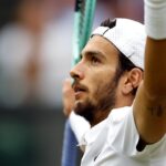 Primo piano di Lorenzo Musetti in divisa bianca per Wimbledon